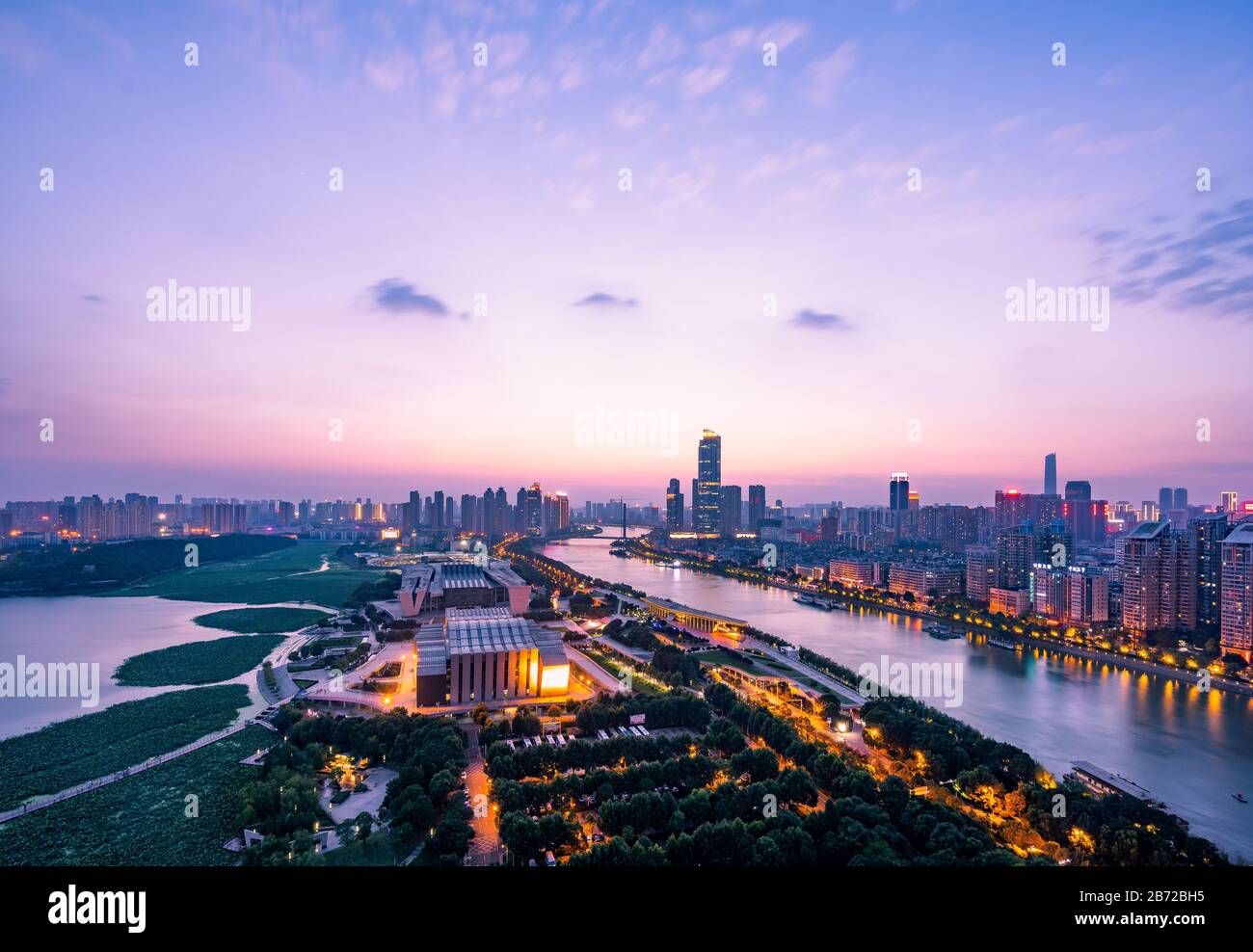 Beautiful wide-angle night aerial view of  Wuhan city at night.Panoramic skyline and buildings beside yangtze river and Hanjiang. Stock Photo