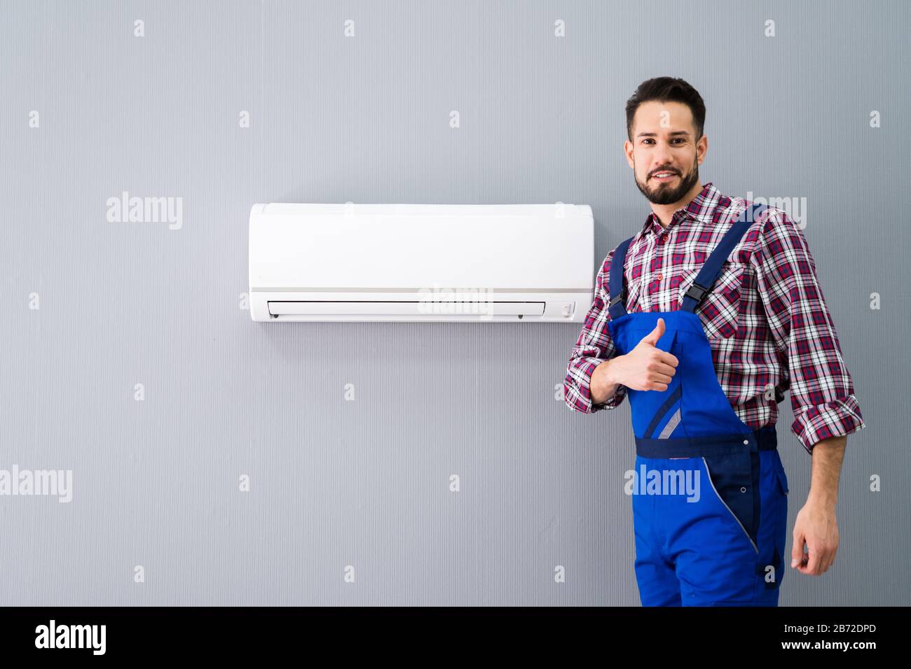 Happy Male Technician Gesturing Thumb Up Near Air Conditioner Stock ...