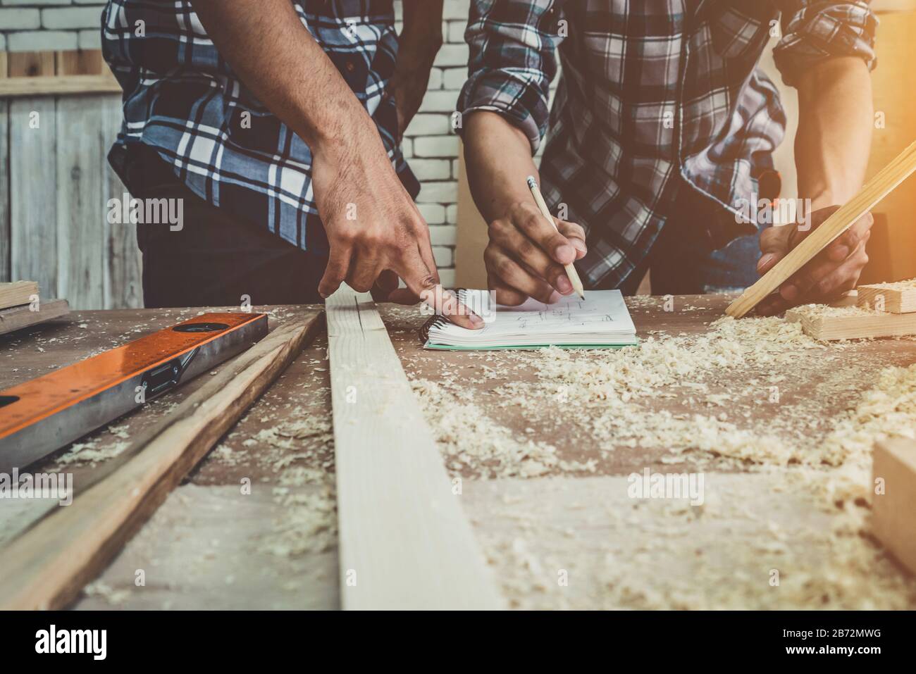 Carpenter working on wood craft at to produce construction