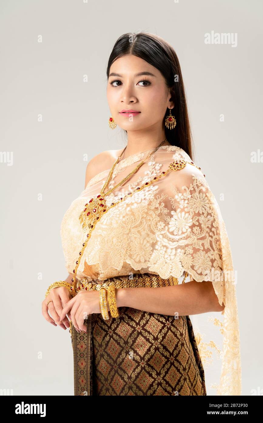 Beautiful Thai woman portrait dress up in traditional thai costume on white background. Thailand culture concept. Stock Photo