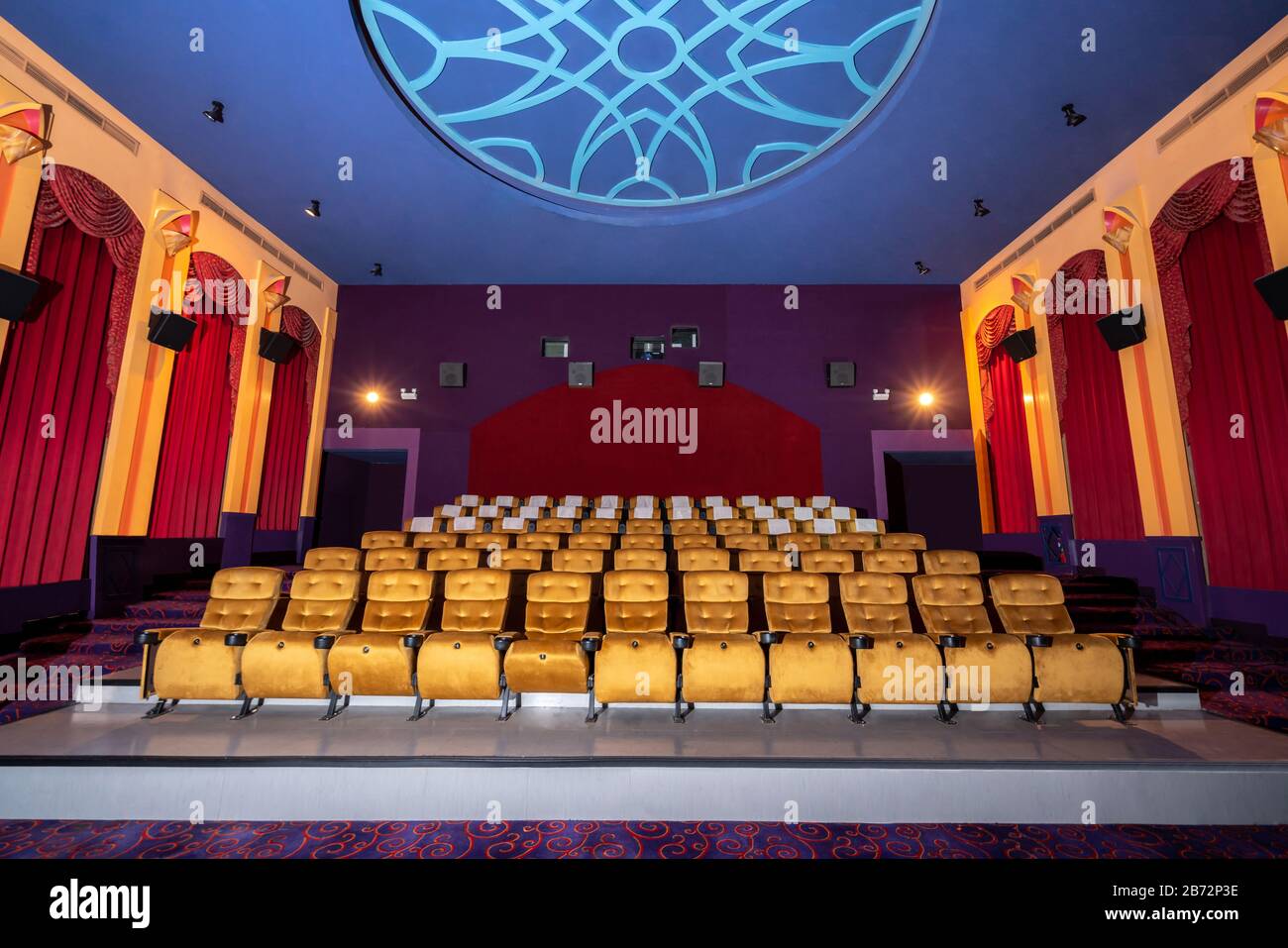 Large cinema theater interior with seat rows for audience to sit in