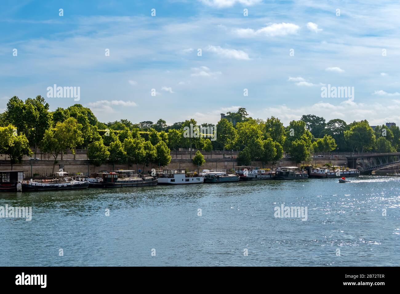 France. Paris. Summer day. River Seine. Many houses on the water moored at granite embankments Stock Photo