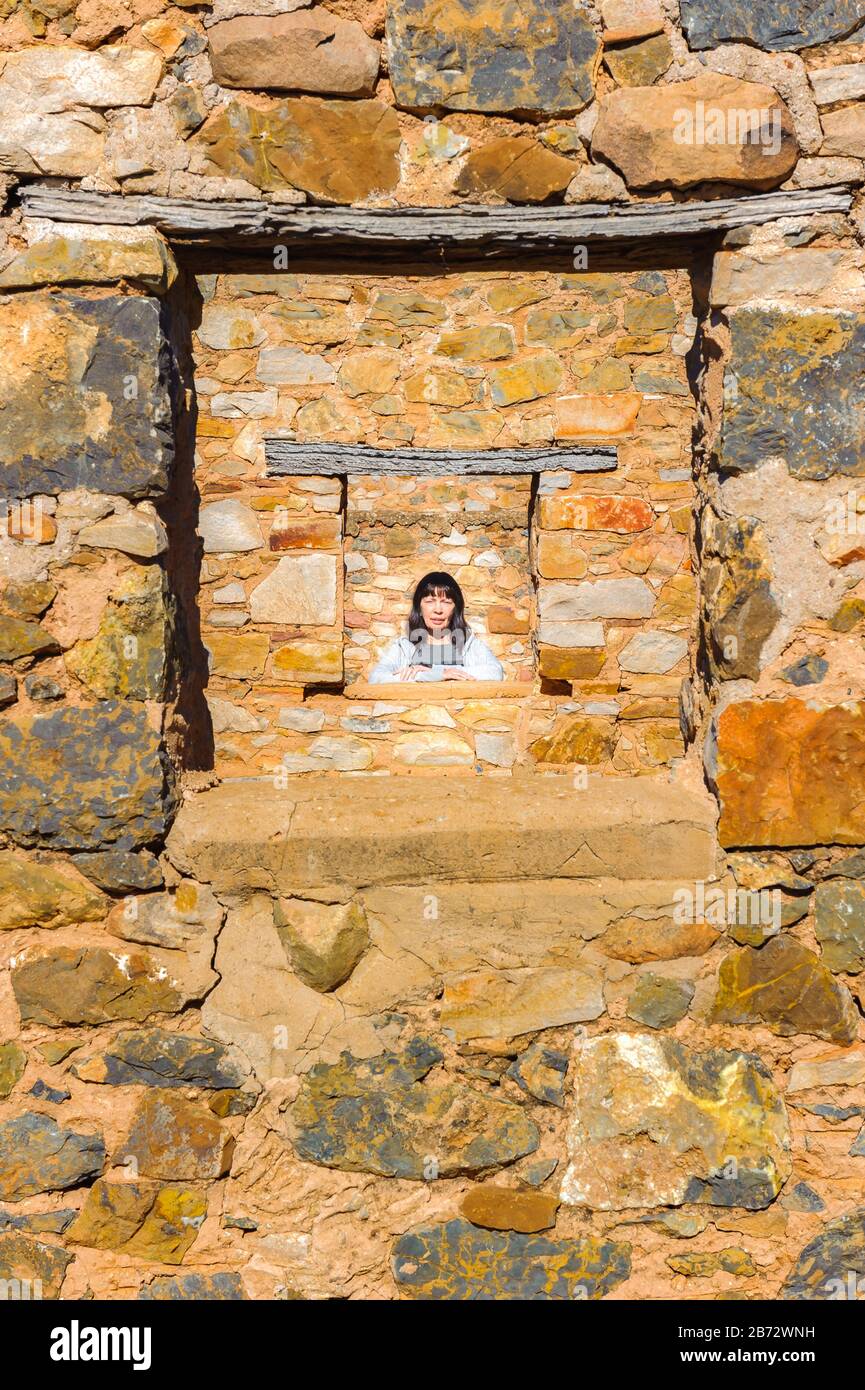 Views female tourist admiring the old Kanyaka homestead and sheep run ruins north of Quorn in South Australia. Stock Photo