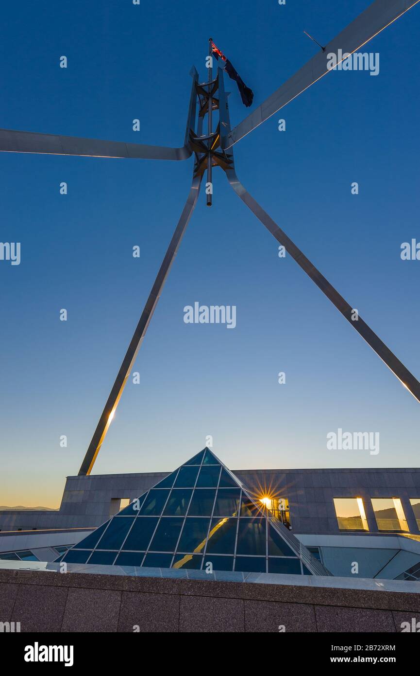 View of the roof top flagpole and glass pyramid skylight on the New Parliament House in Canberra. Stock Photo