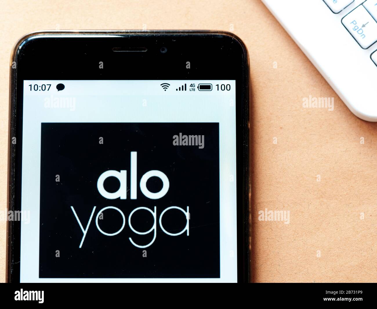 In this photo illustration an Alo Yoga logo seen displayed on a