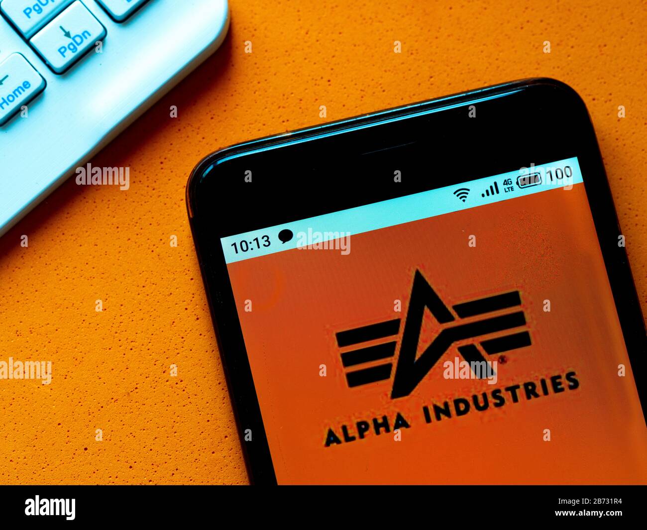 In this photo illustration the Alpha Industries logo is seen displayed on a  smartphone Stock Photo - Alamy