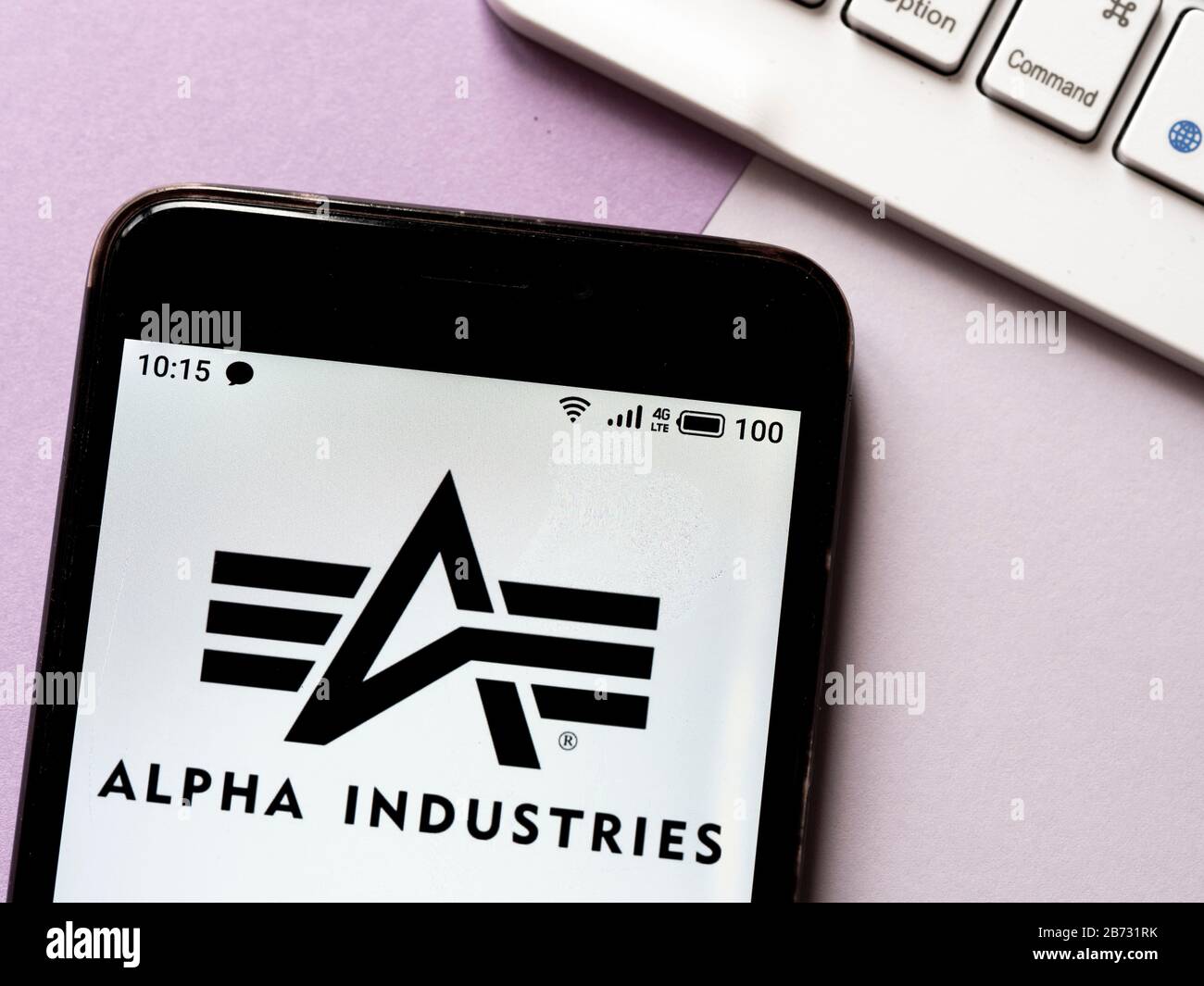 In this photo illustration the Alpha Industries logo is seen displayed on a  smartphone Stock Photo - Alamy