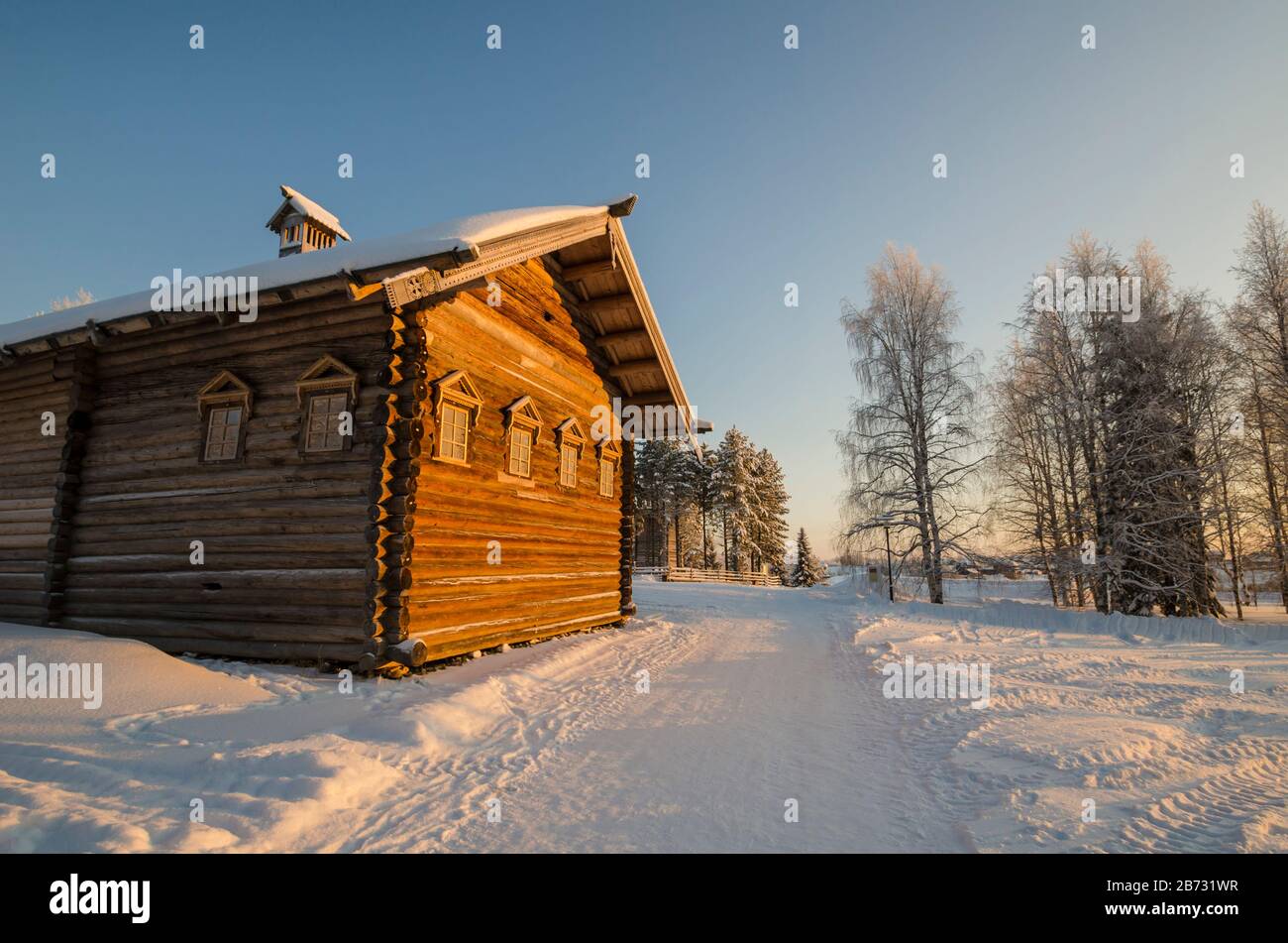 Wooden huts in the museum of wooden architecture 'Small Korely'. Sunset in the village. Russia, Arkhangelsk region Stock Photo