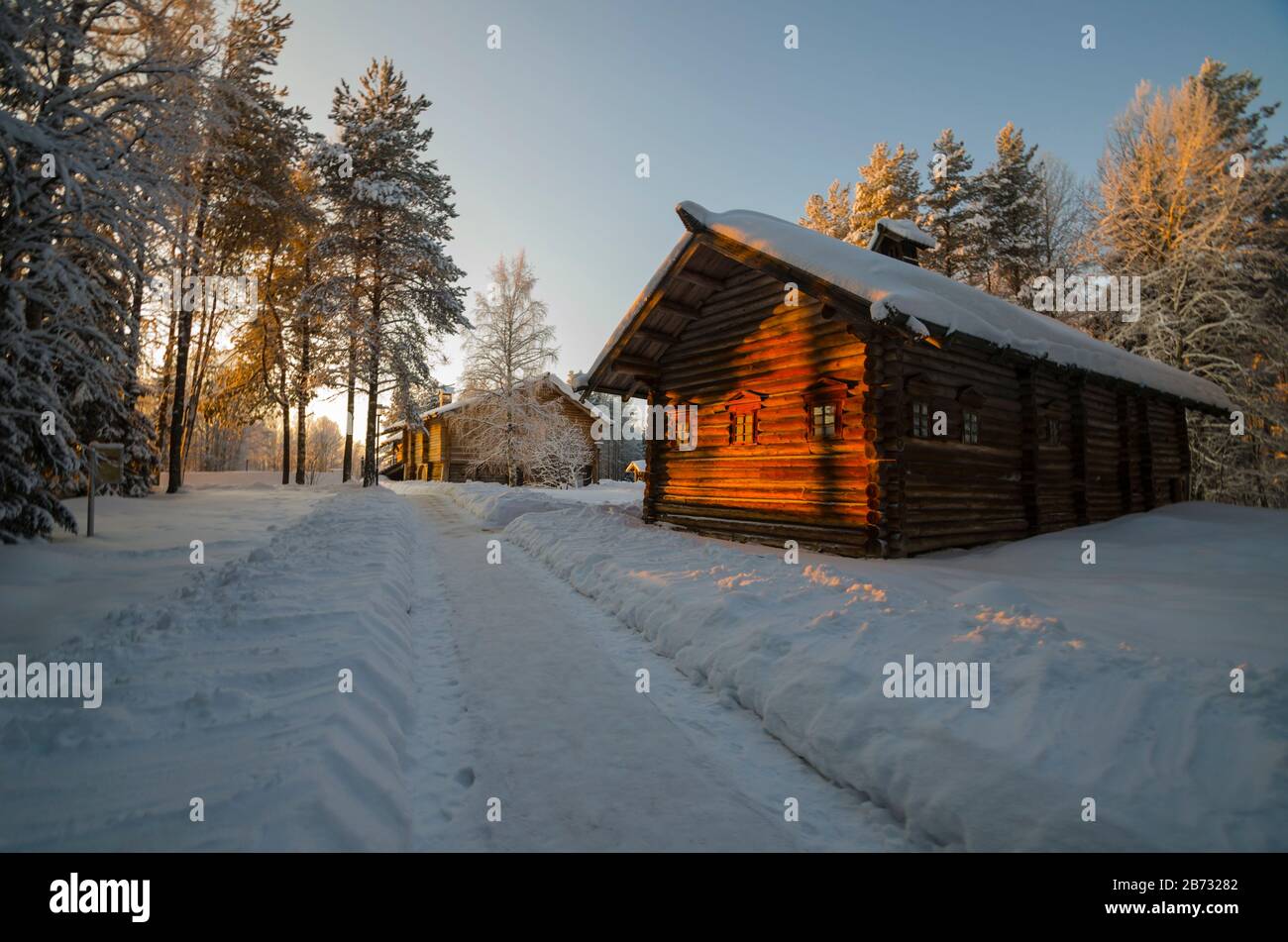 Wooden huts in the museum of wooden architecture 'Small Korely'. Sunset in the village. Russia, Arkhangelsk region Stock Photo
