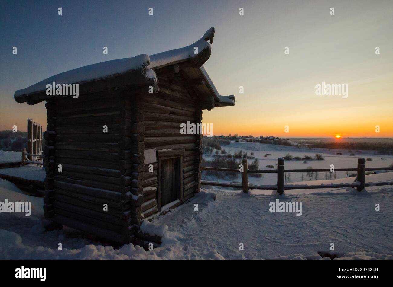 Wooden huts in the museum of wooden architecture 'Small Korely'. Sunset in the village. Russia, Arkhangelsk region Stock Photo