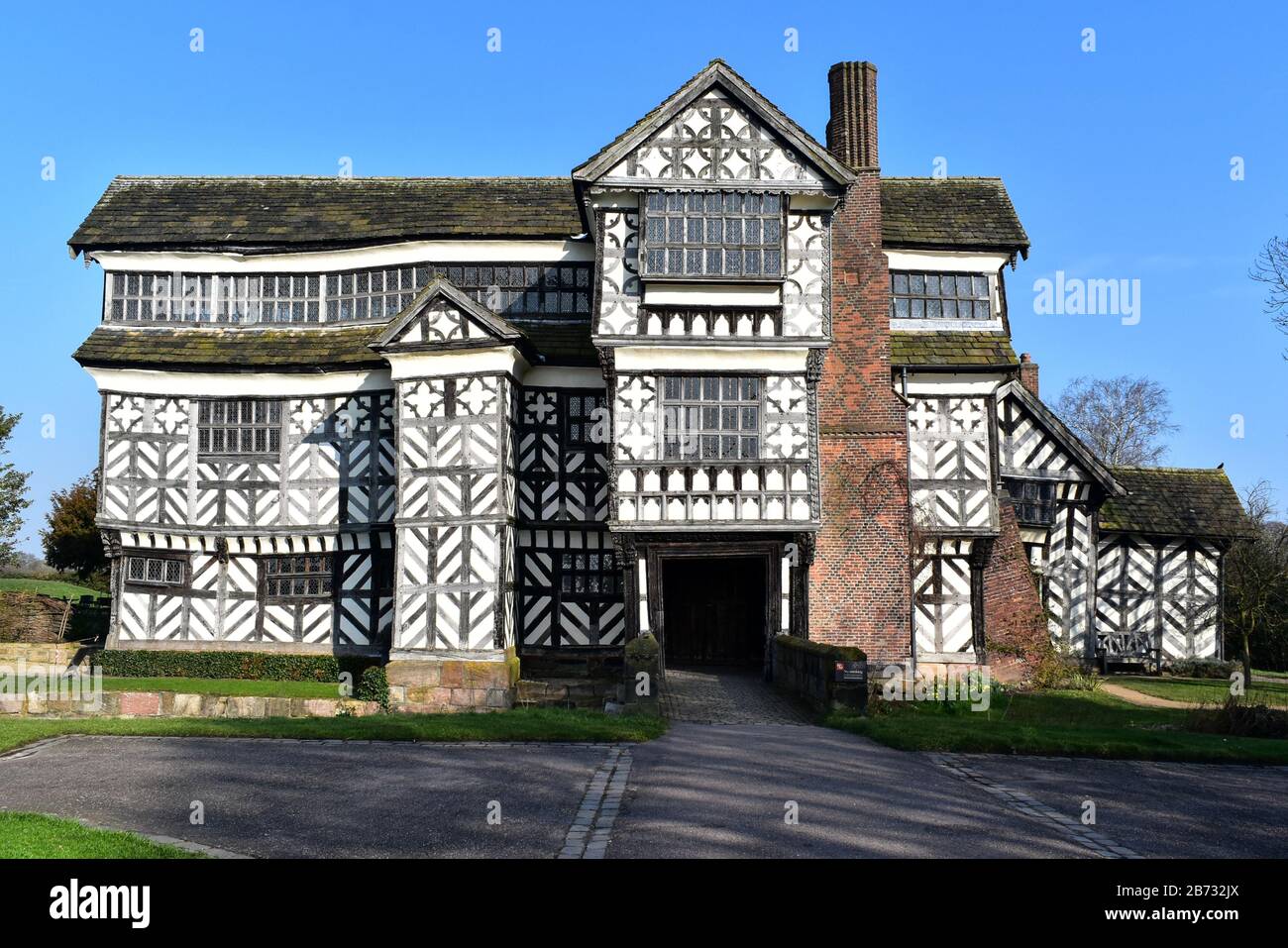 Bridge across the moat and the entrance to Little Moreton Hall. Stock Photo