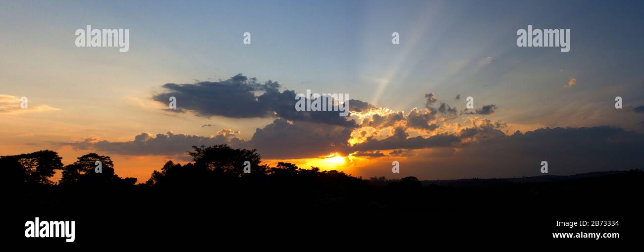 The sun sets over the Kibale National Park hills. The park is gradually becoming isolated and surrounded in uncontrolled habitat degradation Stock Photo