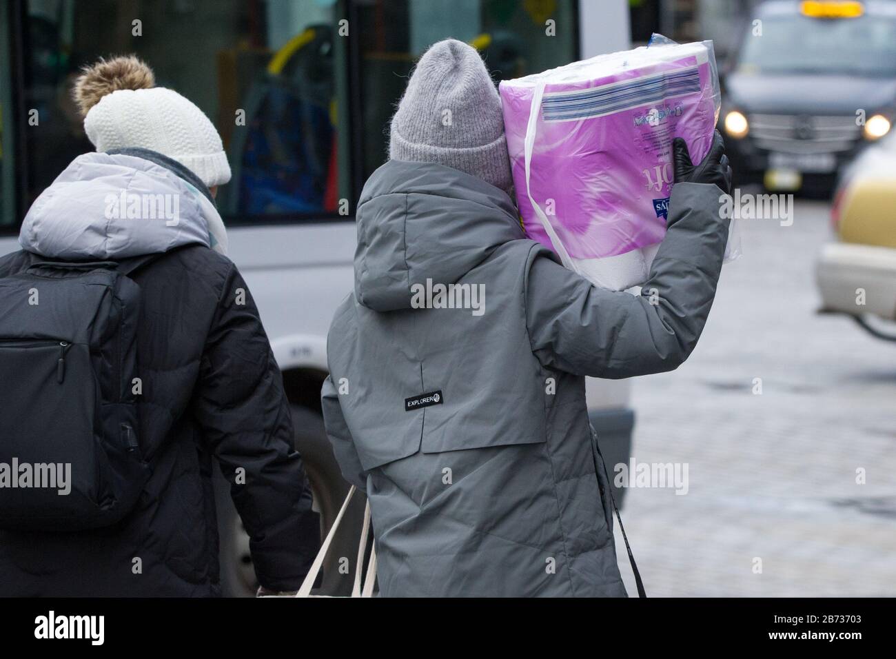 Edinburgh, UK. 13th Mar, 2020. Pictured: People seen on the Royal Mile in Edinburgh with bumper pack of toilet paper, due to panic buying as the shops are now rationing the supply and purchase of toilet paper and every day consumables due to the cause of Coronavirus. Credit: Colin Fisher/Alamy Live News Stock Photo