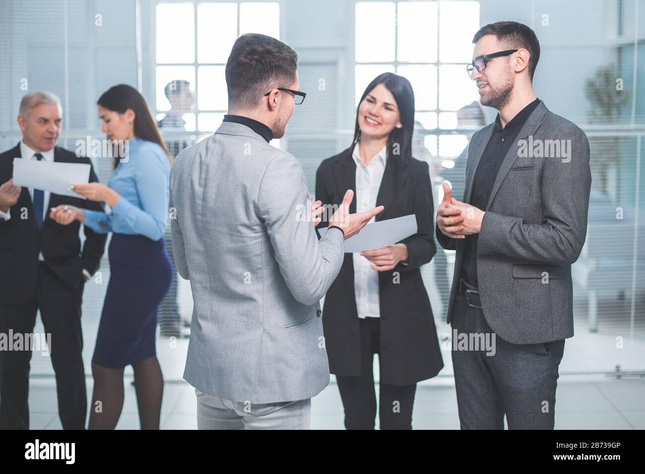 group of business people standing in the office lobby Stock Photo - Alamy