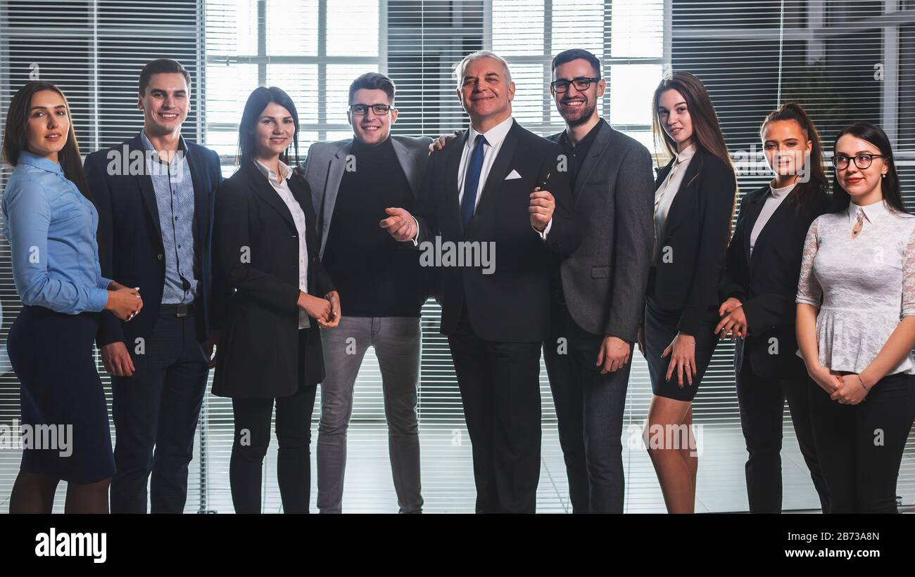 group of happy business people standing in the office lobby Stock Photo ...