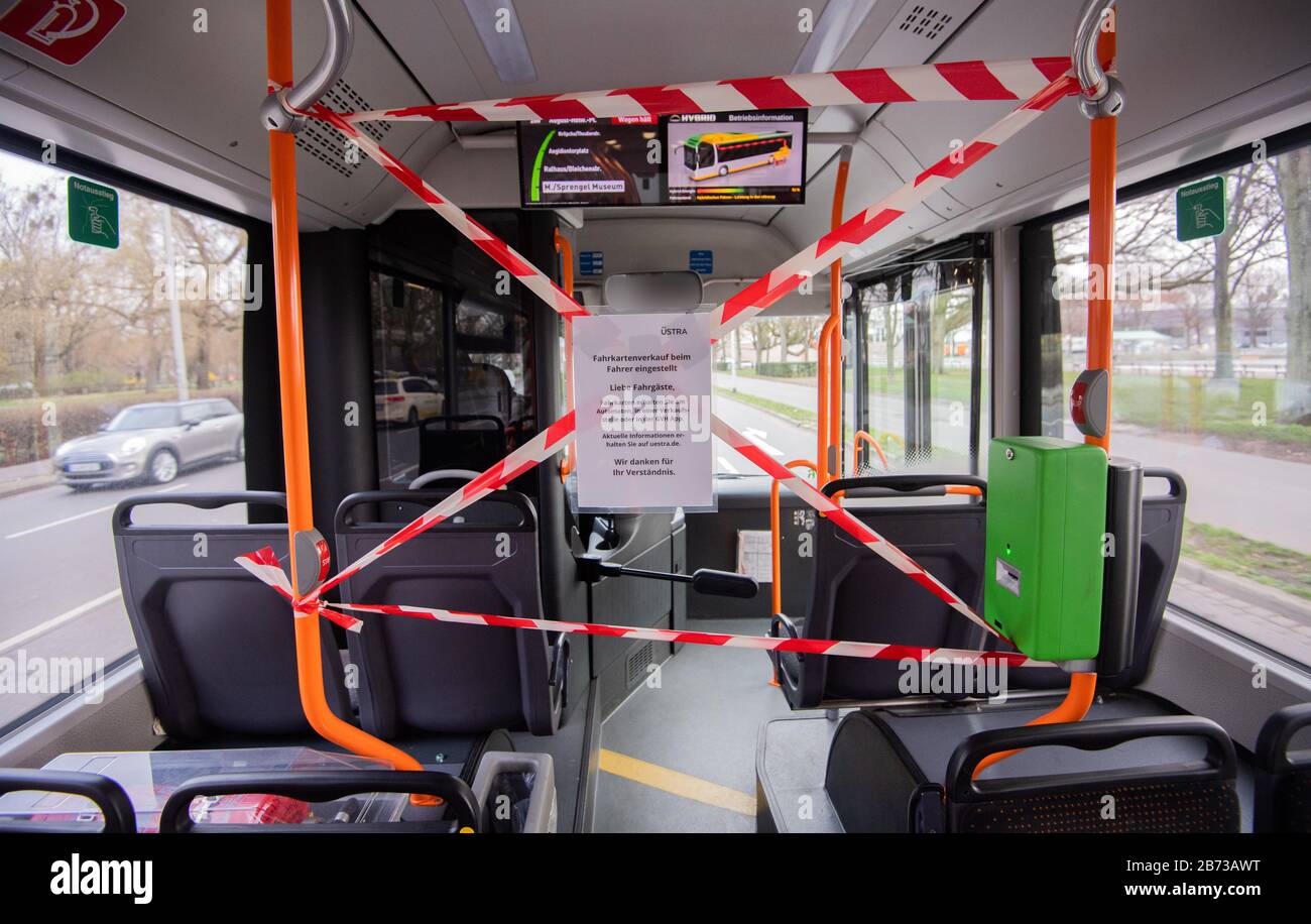 Hanover, Germany. 13th Mar, 2020. The front rows of seats and the front entrance door of a public bus of Üstra Hannoversche Verkehrsbetriebe are cordoned off with barrier tape. In order to protect bus drivers from infection with the corona virus, the public transport companies have now sealed off the front part of the bus for passengers. The ticket sale at the driver is stopped. (ATTENTION: The bus driver in the rear-view mirror was made unrecognizable for personal reasons) Credit: Julian Stratenschulte/dpa/Alamy Live News Stock Photo