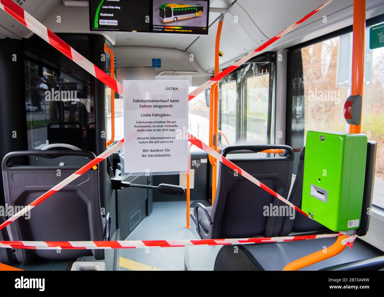 Hanover, Germany. 13th Mar, 2020. The front rows of seats and the front entrance door of a public bus of Üstra Hannoversche Verkehrsbetriebe are cordoned off with barrier tape. In order to protect bus drivers from infection with the corona virus, the public transport companies have now sealed off the front part of the bus for passengers. The ticket sale at the driver is stopped. (ATTENTION: The bus driver in the rear-view mirror was made unrecognizable for personal reasons) Credit: Julian Stratenschulte/dpa/Alamy Live News Stock Photo