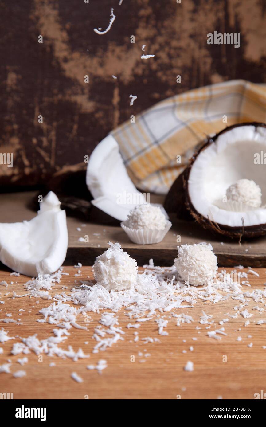 Close up of sweet chocolate coconut truffles and coconut with white pulp, coconut chip. White chocolate coconut sweets and coconut shell, coconut flak Stock Photo