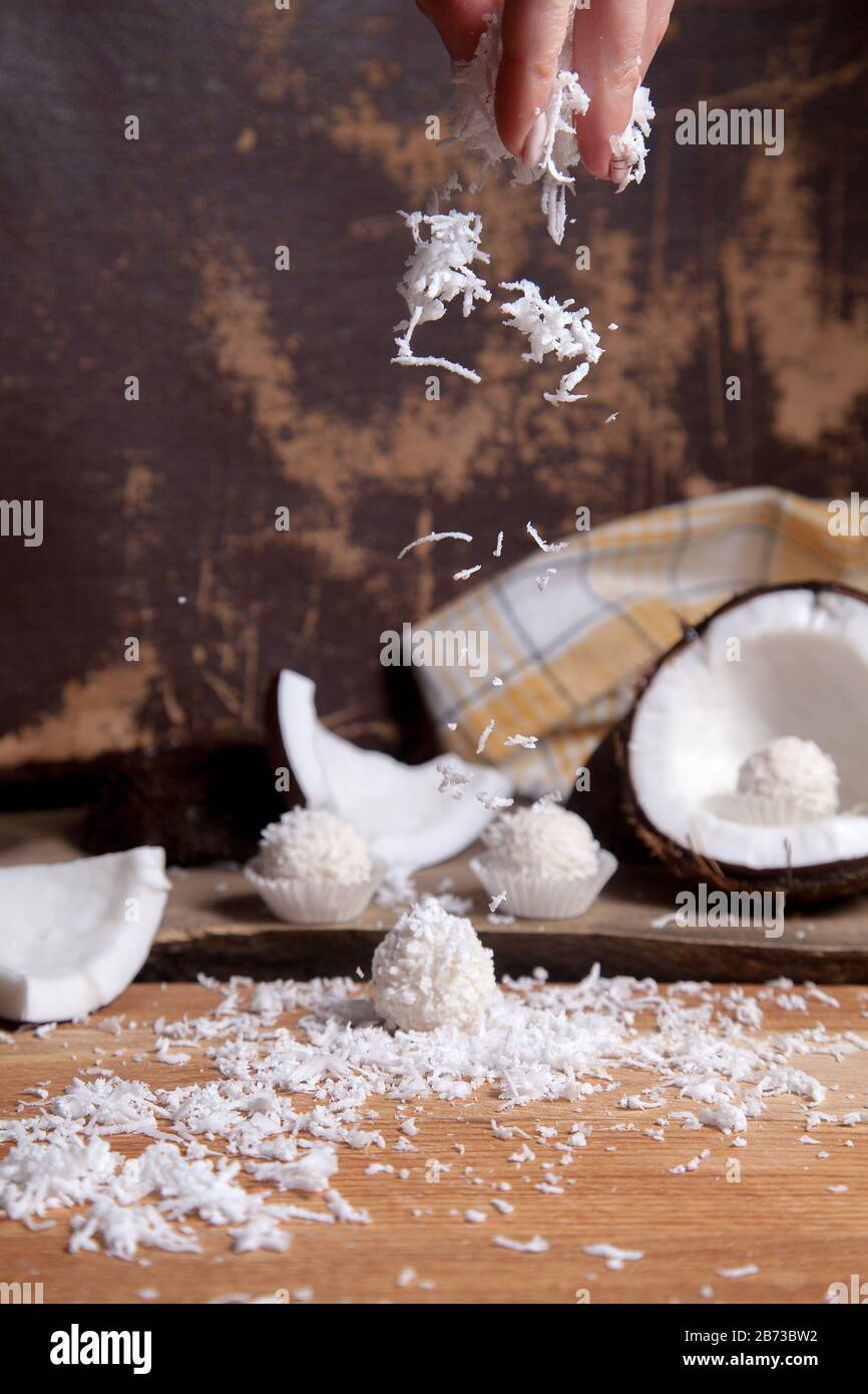 Close up of sweet chocolate coconut truffles and coconut with white pulp, coconut chip. White chocolate coconut sweets and coconut shell, coconut flak Stock Photo