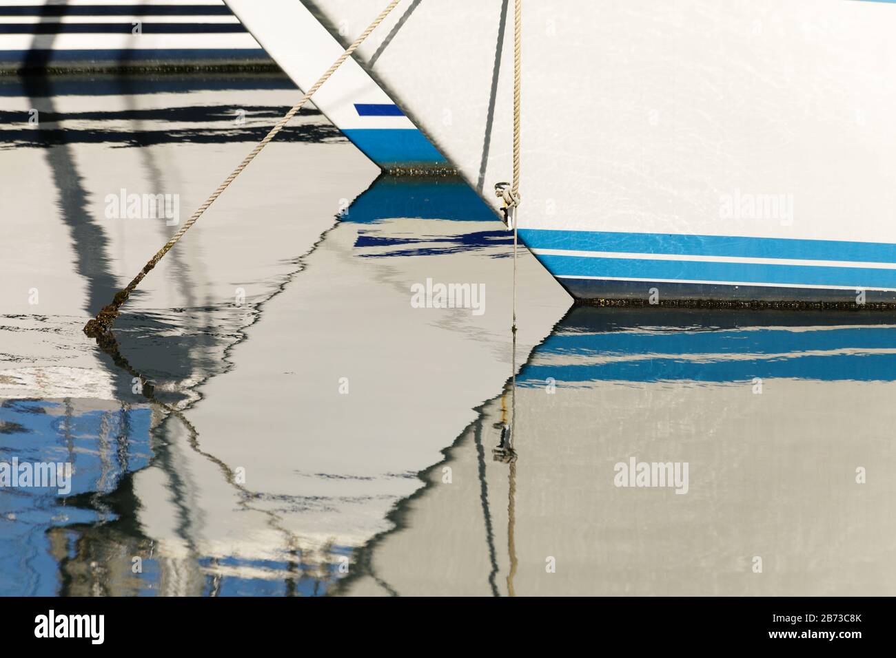 Abstract angular relections of boats in the marina waters in Palermo, Sicily Stock Photo