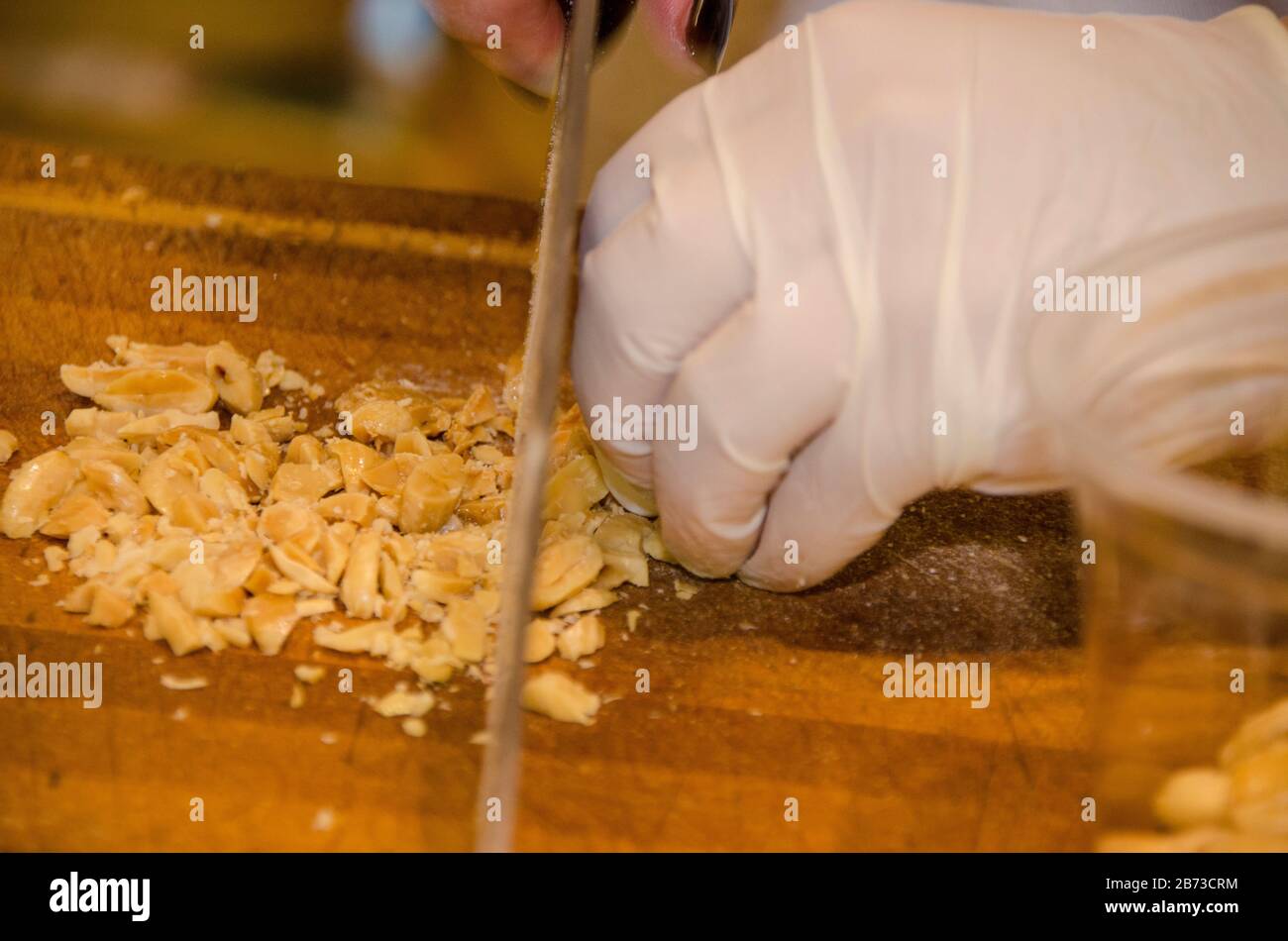 A chef is demonstrating the cutting of cheese at a baking workshop Stock Photo