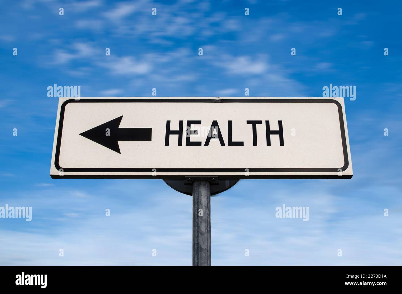 Health road sign, arrow on blue sky background. One way blank road sign with copy space. Arrow on a pole pointing in one direction. Stock Photo
