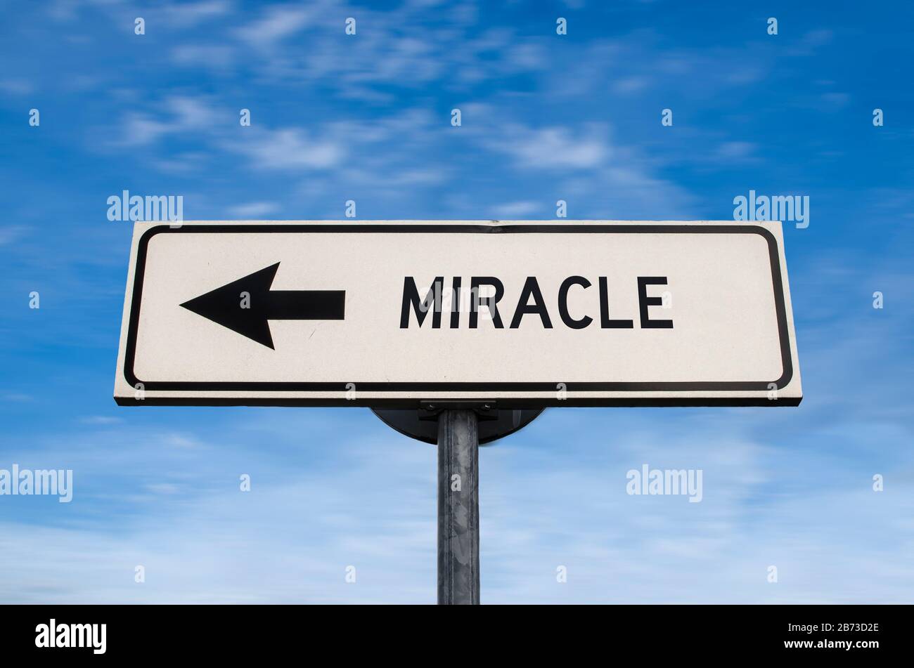 Miracle road sign, arrow on blue sky background. One way blank road sign with copy space. Arrow on a pole pointing in one direction. Stock Photo