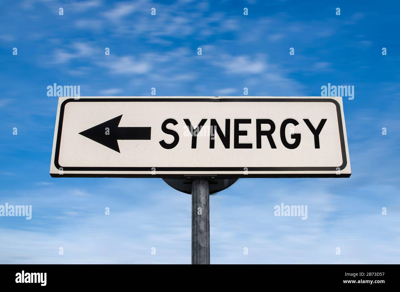 Synergy road sign, arrow on blue sky background. One way blank road sign with copy space. Arrow on a pole pointing in one direction. Stock Photo