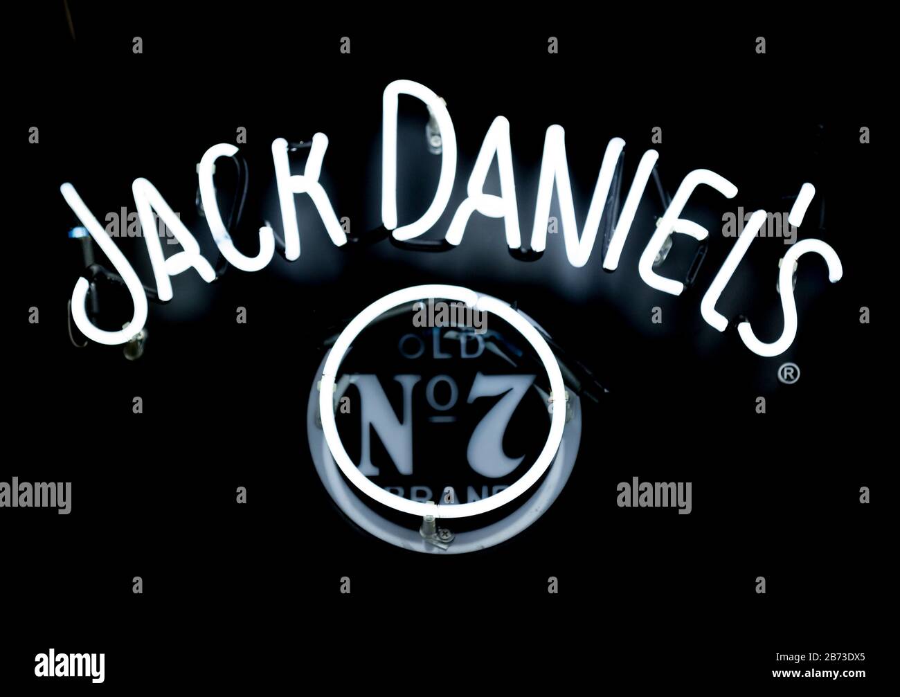 Close-up on a neon light shaped into Jack Daniel's logo. Stock Photo