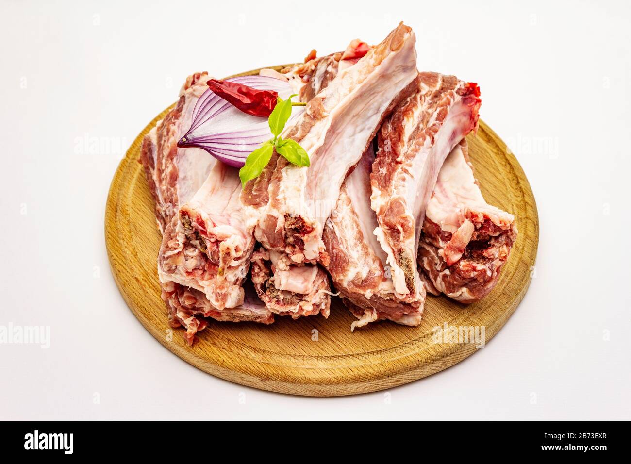 Raw pork ribs isolated on white background. Round wooden cutting board ...