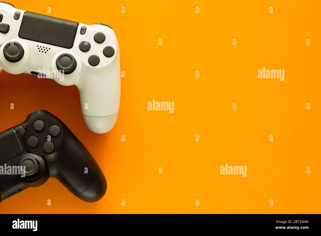 Stock photo of two gamepads on a yellow background and copy space on ...