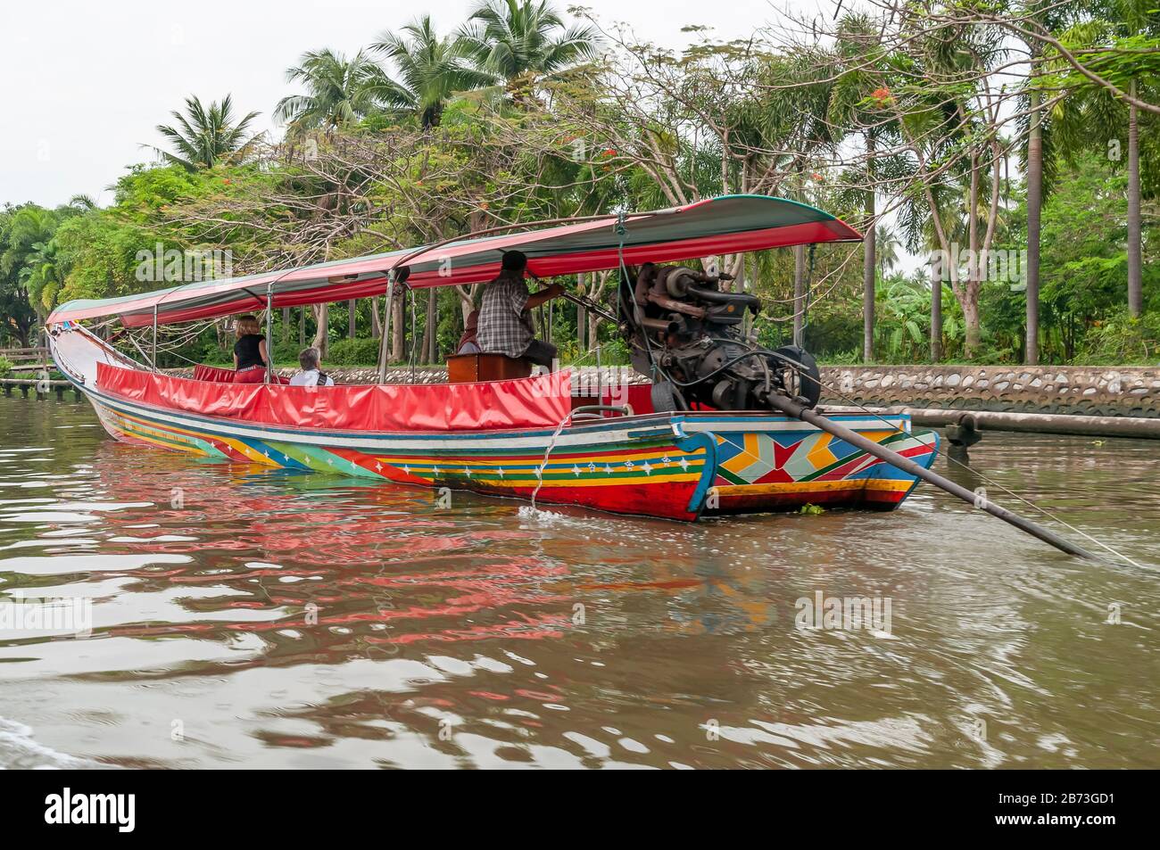 Colorful long tail boat sails in a canal in the center of Bangkok, Thailand, to make tourists take a tour of the city Stock Photo