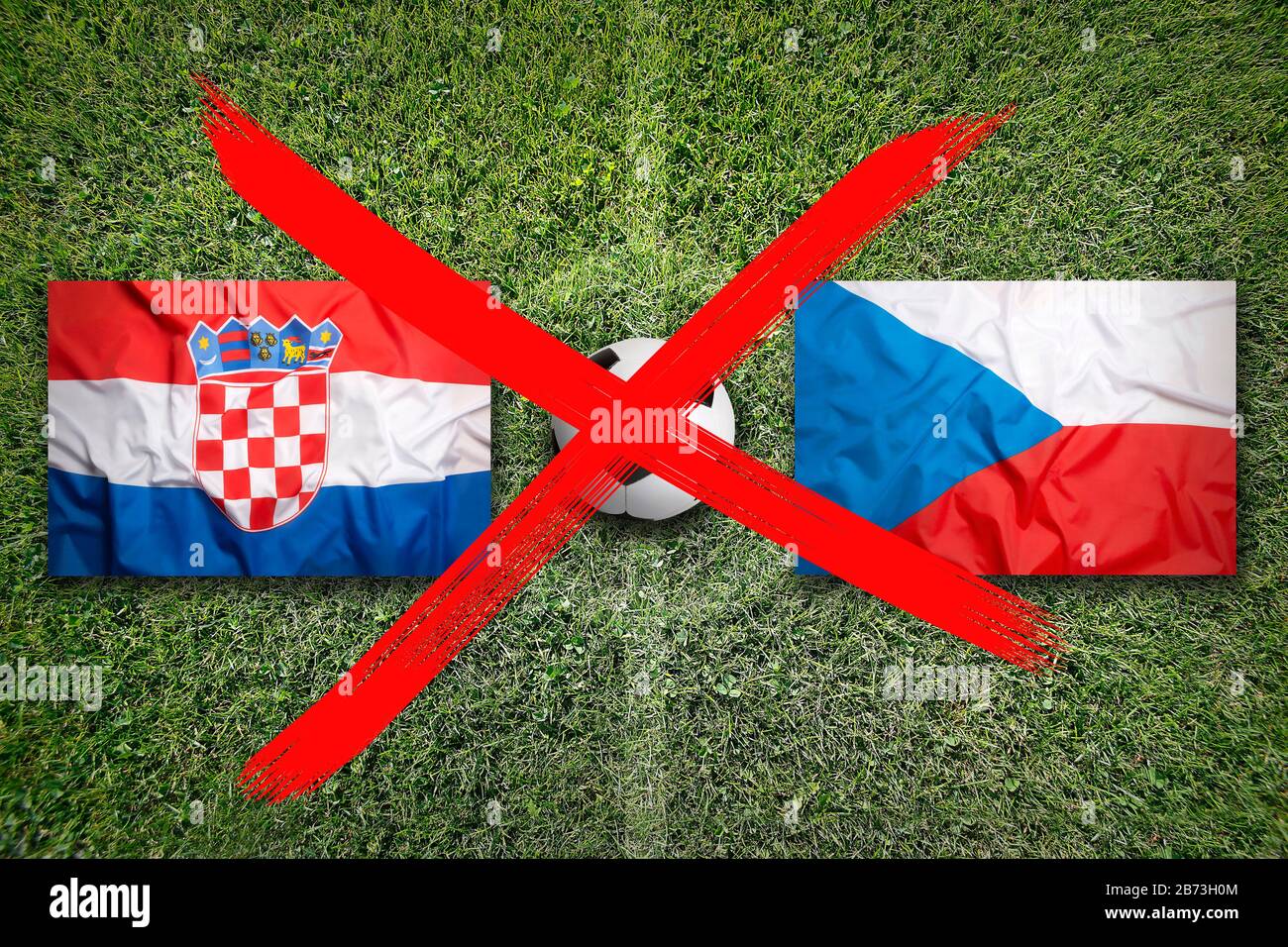Canceled soccer game, Croatia vs. Czech Republic flags on green soccer field Stock Photo