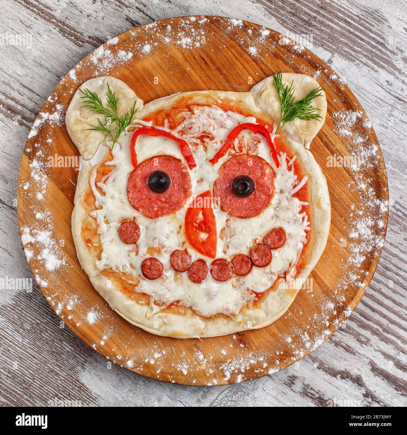 Baby pizza in the form of an animal's face. Children's menu Stock Photo