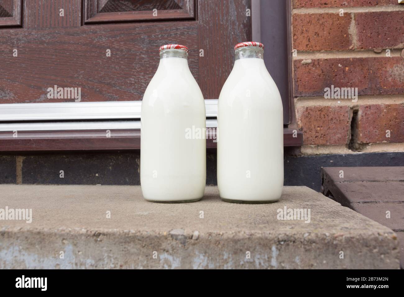 Fresh semi skimmed milk in recyclable glass bottles delivered to the door by a traditional milk man in the UK Stock Photo