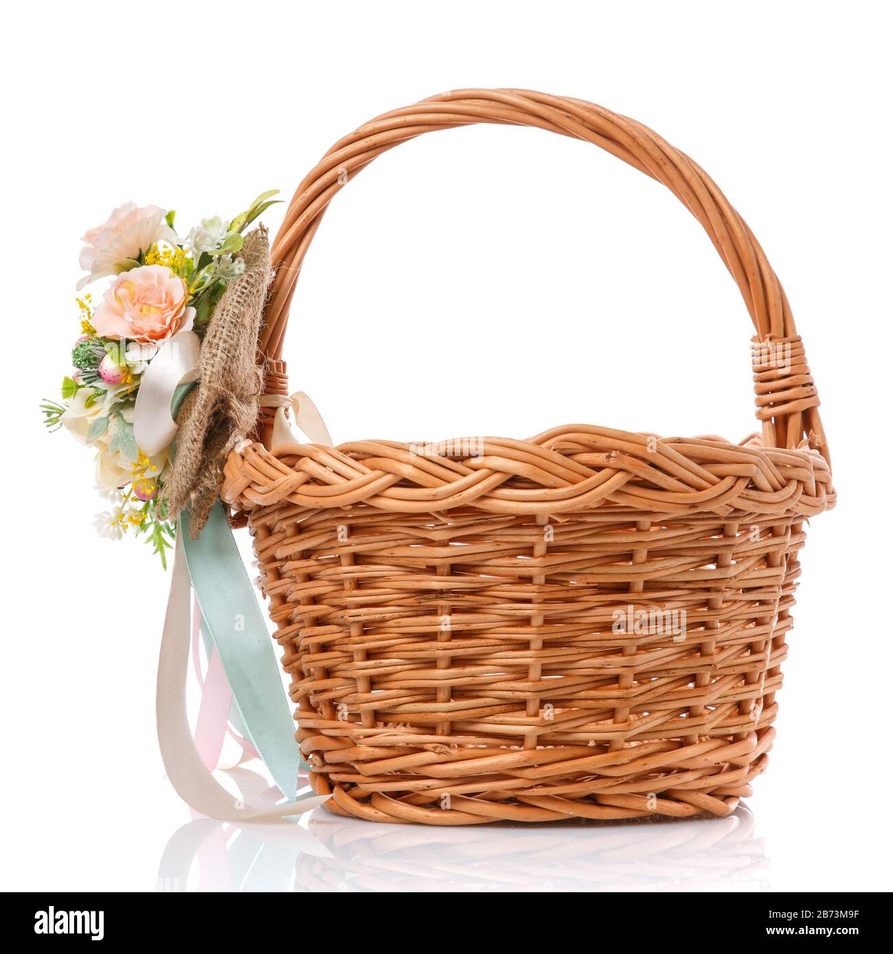 Wicker basket decorated with flowers on white background Stock Photo ...