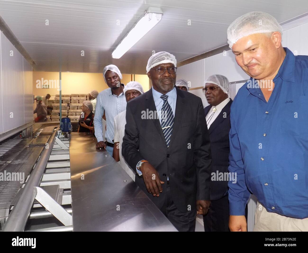 (200313) -- WINDHOEK, March 13, 2020 (Xinhua) -- Namibia's Minister of Industrialization, Trade and SME Development Tjekero Tweya (C) visits a bread manufacturing factory in Windhoek, Namibia, March 12, 2020. Namibia's Minister of Industrialization, Trade and SME Development Tjekero Tweya on Thursday inaugurated the country's first-ever state-of-the-art bread manufacturing factory valued at around 135 million Namibia dollars (about 8.4 million U.S. dollars). The factory system runs like a conveyor belt through the entire process of mixing, fermenting, baking and packaging. (Photo by Musa C Kas Stock Photo