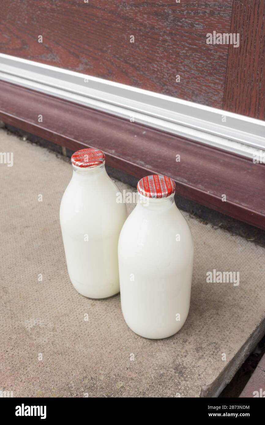 Fresh semi skimmed milk in recyclable glass bottles delivered to the door by a traditional milk man in the UK Stock Photo