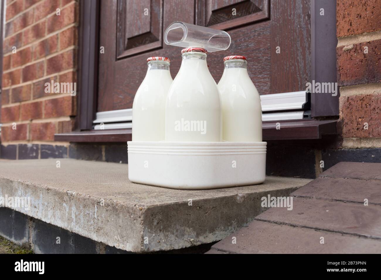 Fresh semi skimmed milk in recyclable glass bottles delivered to the door by a traditional milk man in the UK Stock Photo