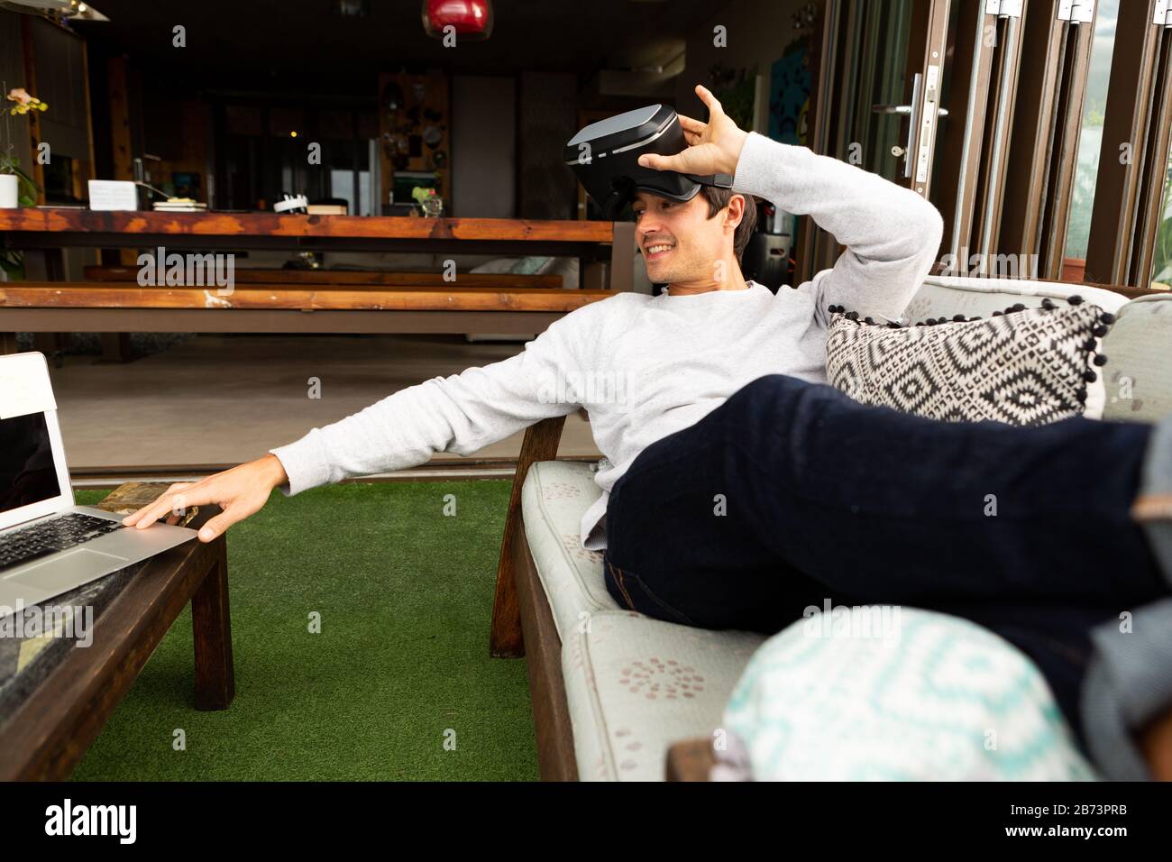 Man using virtual reality headset on a terrace Stock Photo