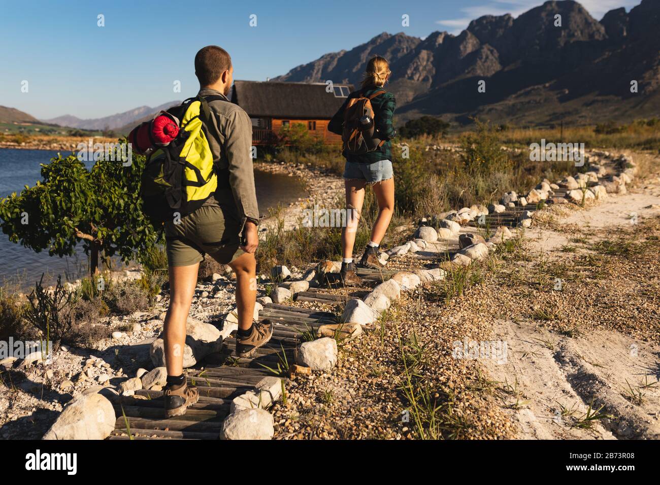 Rear view of couple walking on a path Stock Photo - Alamy