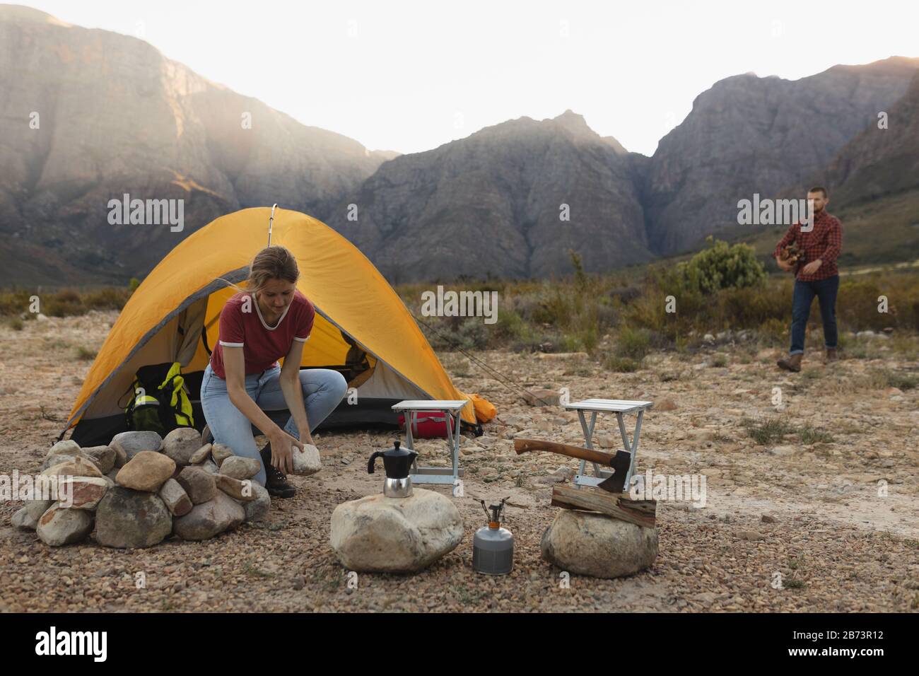 Front view of couple installing the camp together Stock Photo