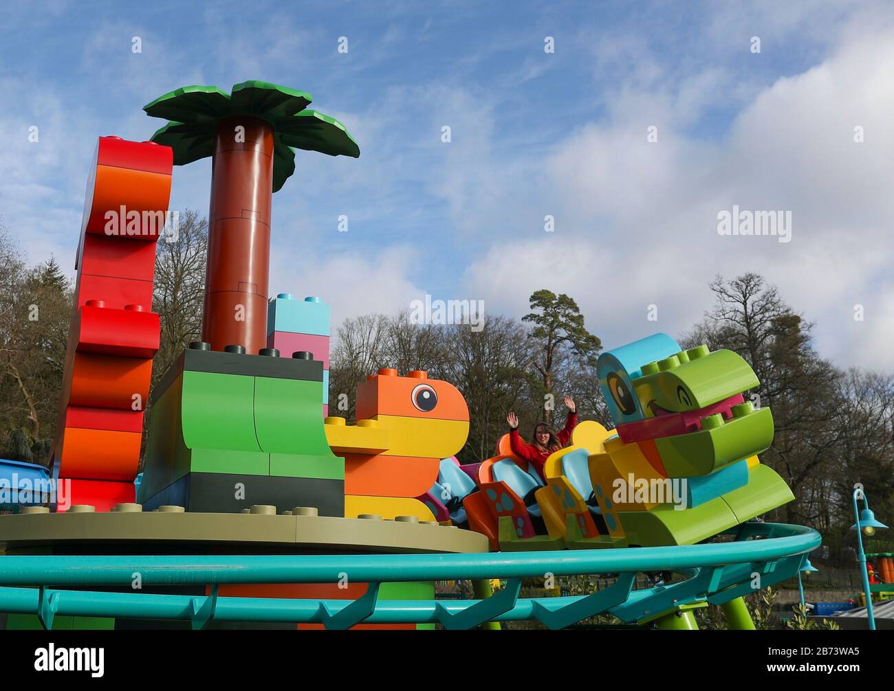 Creative lead Rosie Brailsford tests the world's first DUPLO Dino coaster at LEGOLAND Windsor Resort, Berkshire, as part of a makeover of the bigger and better DUPLO Valley land which opens to the public on Saturday 14 March. Stock Photo