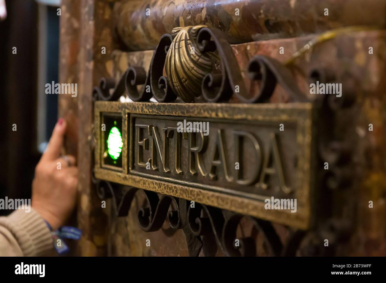 A green light signals the next person to enter the shrine containing the crypt of Saint James in the Cathedral of Santiago de Compostela in Galicia, S Stock Photo