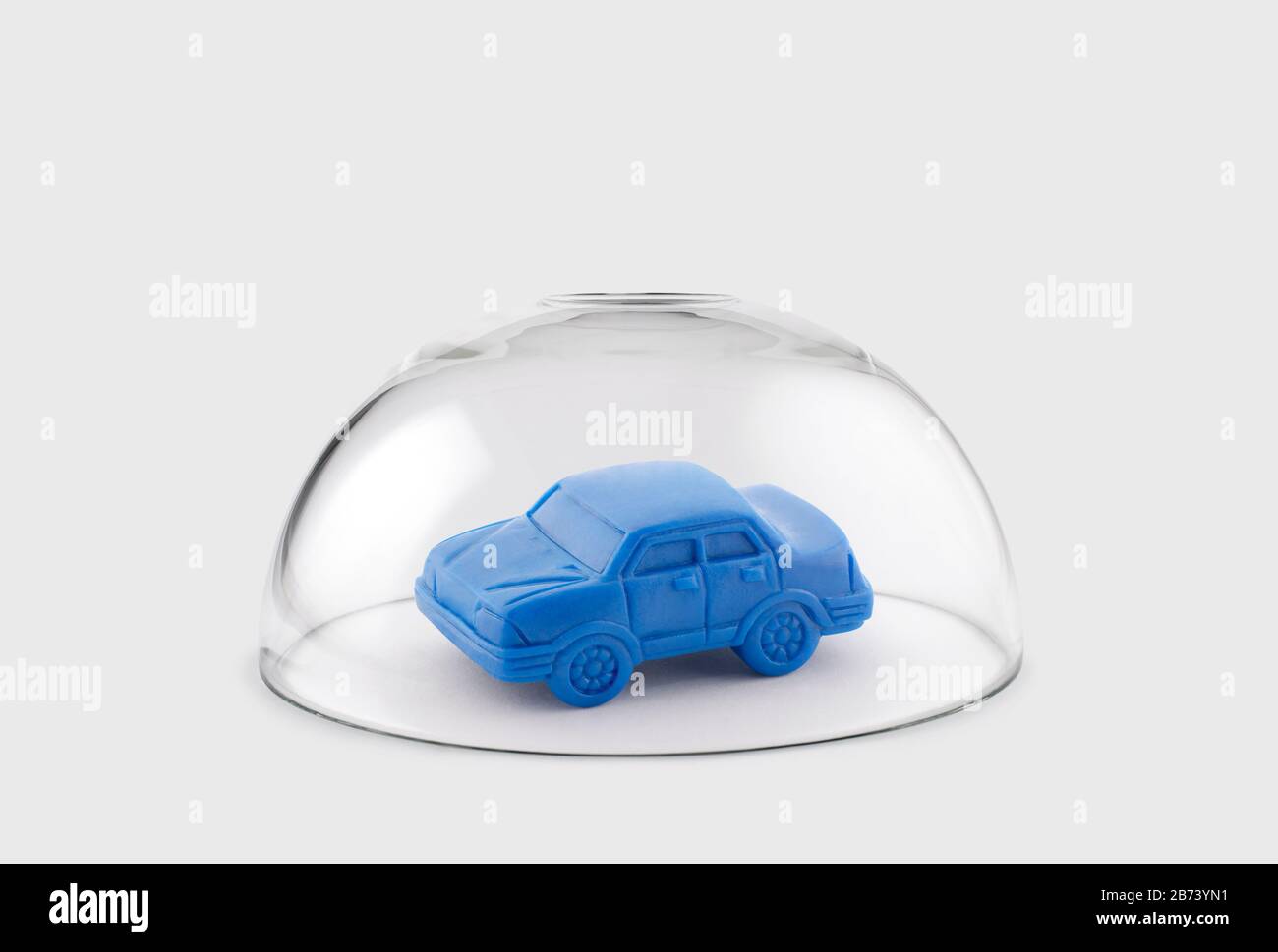 Blue toy car protected under a glass dome Stock Photo