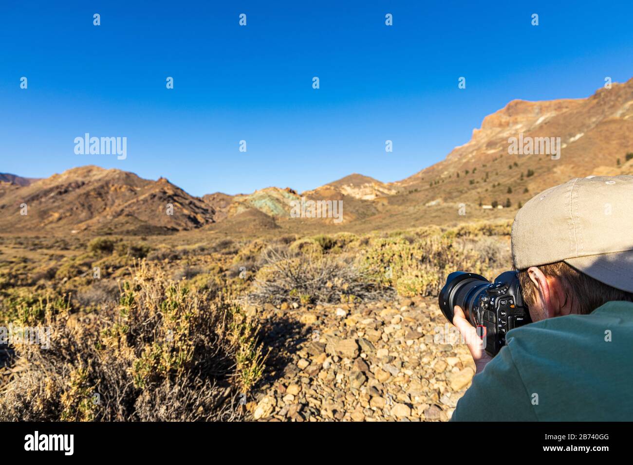 Photographer making a photograph in the volcanic landscape of the National park, Las canadas del Teide, Tenerife, Canary Islands, Spain Stock Photo