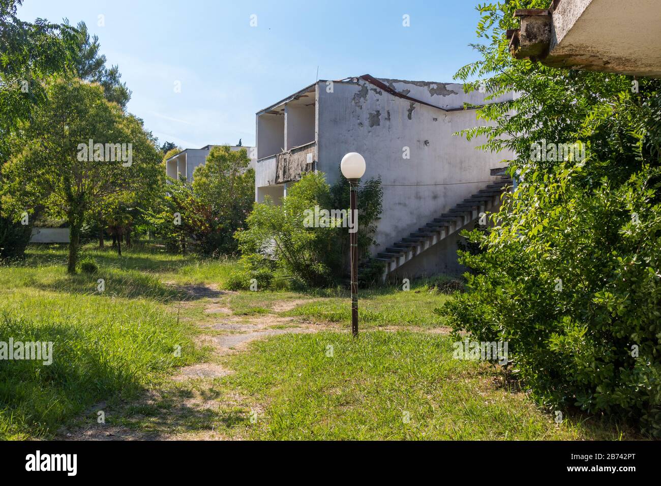 abandoned, neglected and overgrown holiday complex at Velika Plaza, Ulcinj, Montenegro Stock Photo