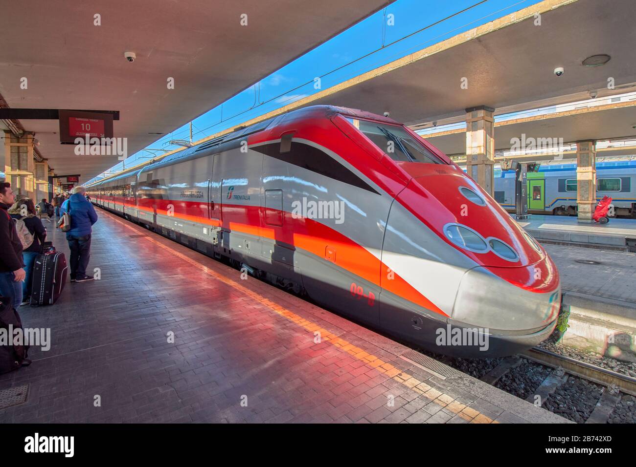 FLORENCE ITALY PASSENGERS WAITING FOR THE TRENITALIA TRAIN ARRIVING AT ...