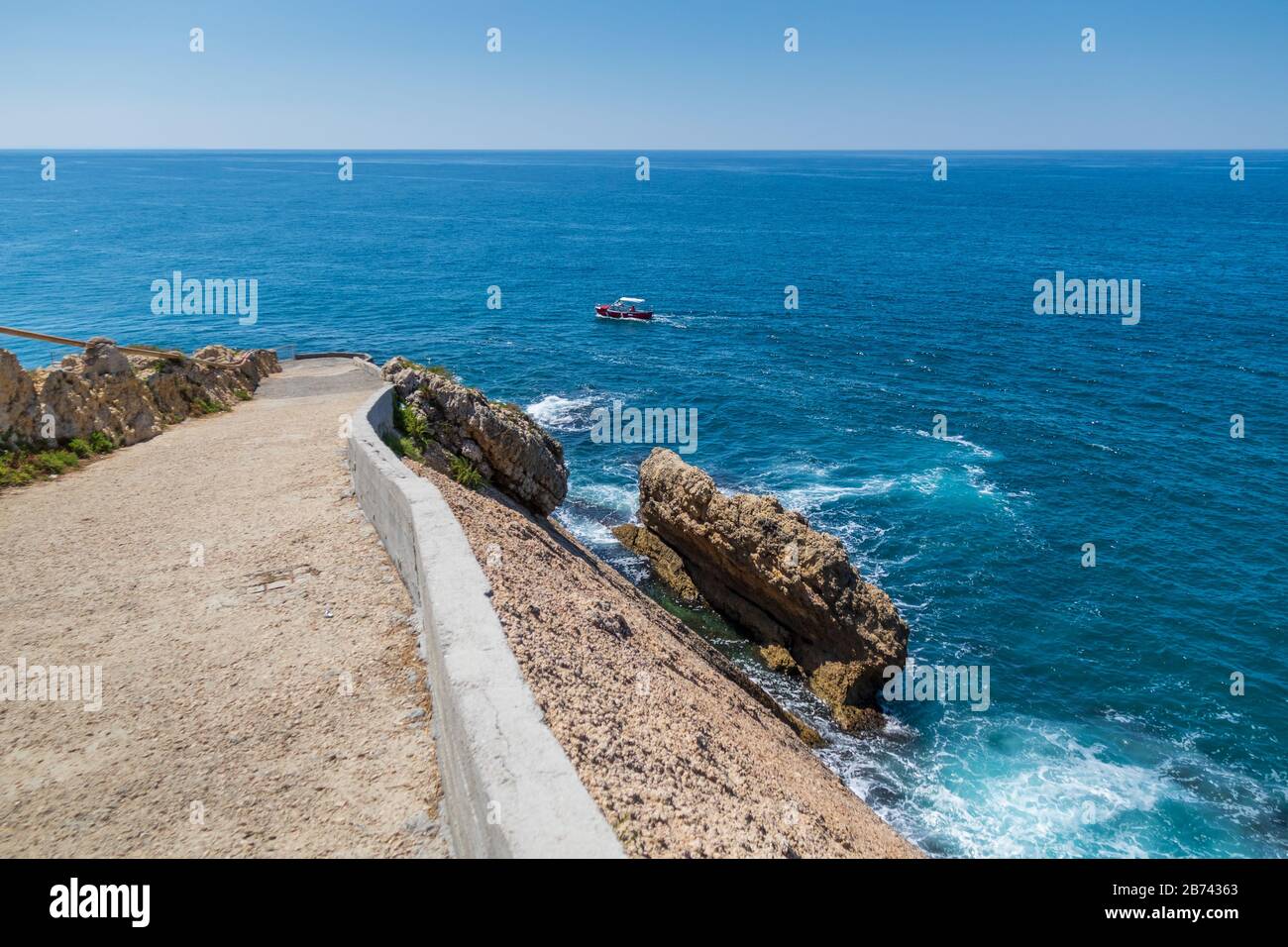 concrete cliff edge overlooking blue Adriatic Sea Stock Photo