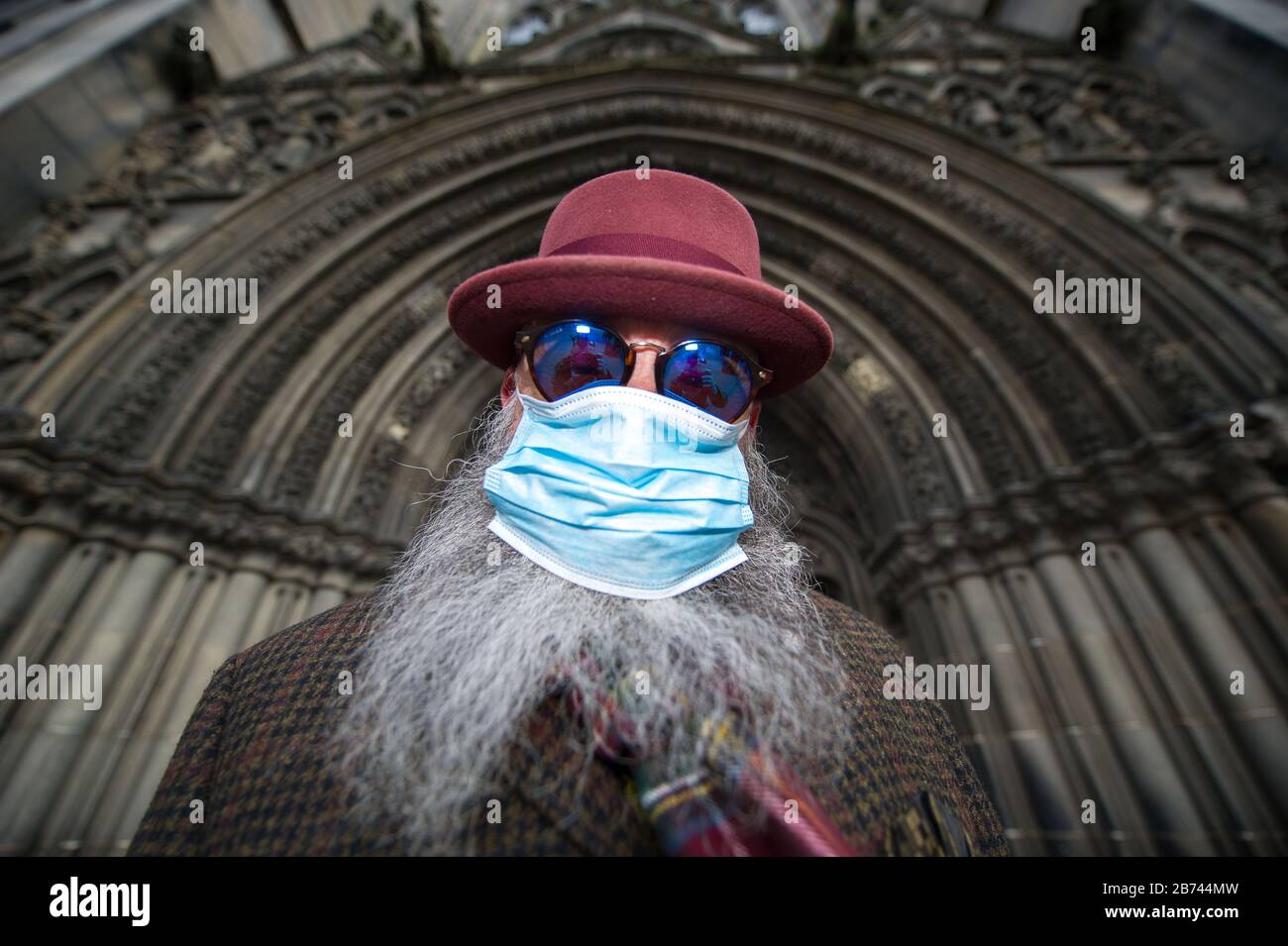 Edinburgh, UK. 13th Mar, 2020. Pictured: Man seen wearing surgical mask and covering his nose and mouth due to the Coronavirus pandemic. Credit: Colin Fisher/Alamy Live News Stock Photo